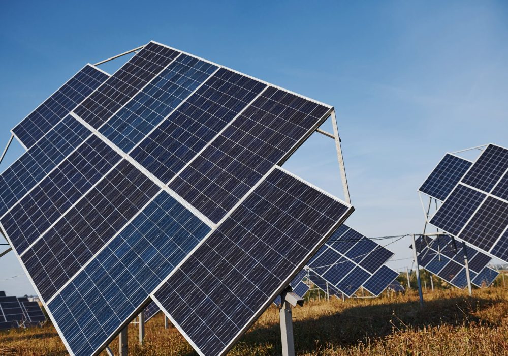 Field with solar batteries at sunny daytime. Conception of ecology and fuel.