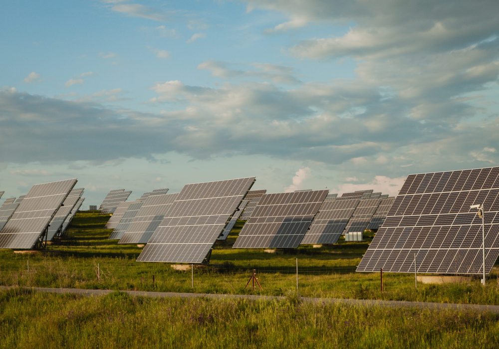 Solar panels in the landscape with a cloudy sky of background